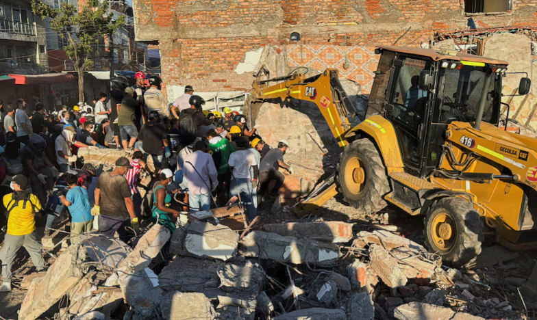  Residents and emergency personnel dig through the debris of a collapsed building following an earthquake, in Cali