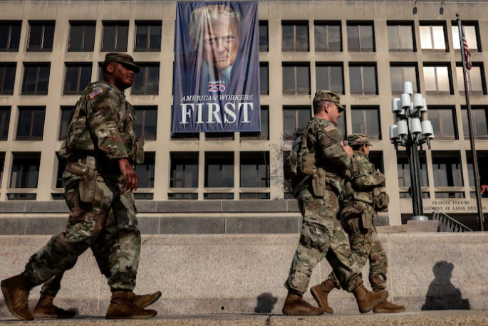 Members of the National Guard walk past the U.S. Department of Labor in Washington