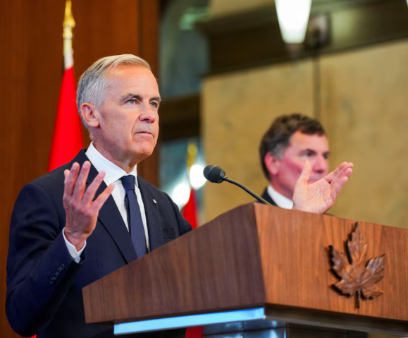 Canada Prime Minister Mark Carney speaks with the news media