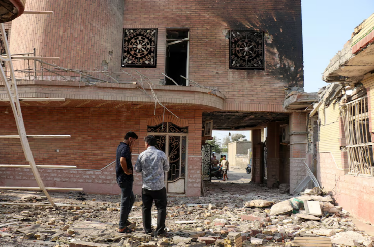 Rubble lies around damaged houses following a reported attack near a wedding gathering in Kuhistik, Sirik, Iran