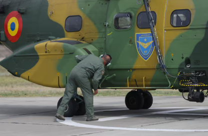 A mechanic at Mihail Kogalniceanu Air Base - also known as MK - inspects a Romanian military helicopter