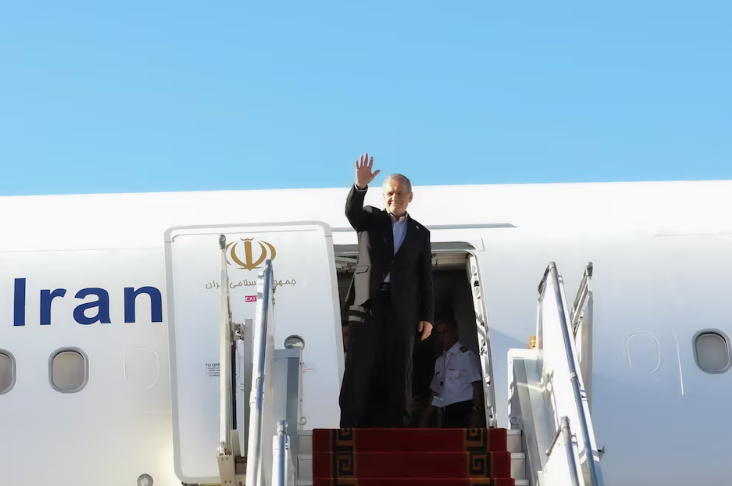 Iranian President Masoud Pezeshkian waves before departing for New York, at Mehrabad Airport in Tehran