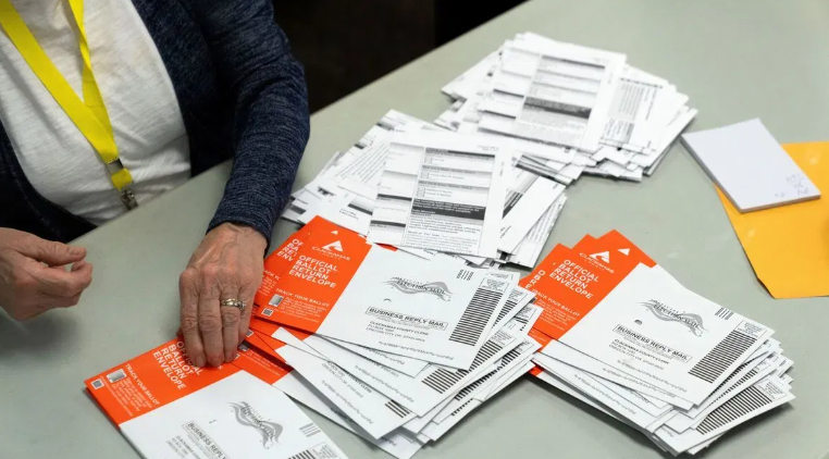 Postal Worker Pleads Not Guilty as DOJ Highlights Mail-In Ballot Security